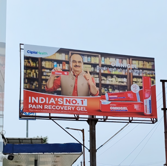 A high-angle outdoor shot of a large billboard for Cipla Health's "Omnigel" pain recovery gel.